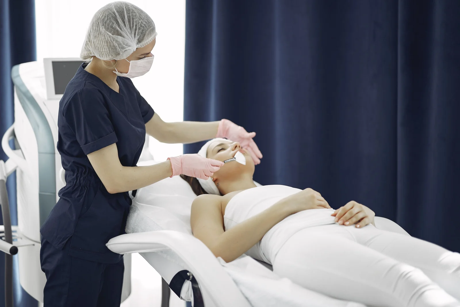 Aesthetician applying a treatment mask